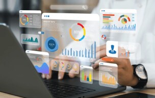 Data analyst reviewing customer data on a laptop